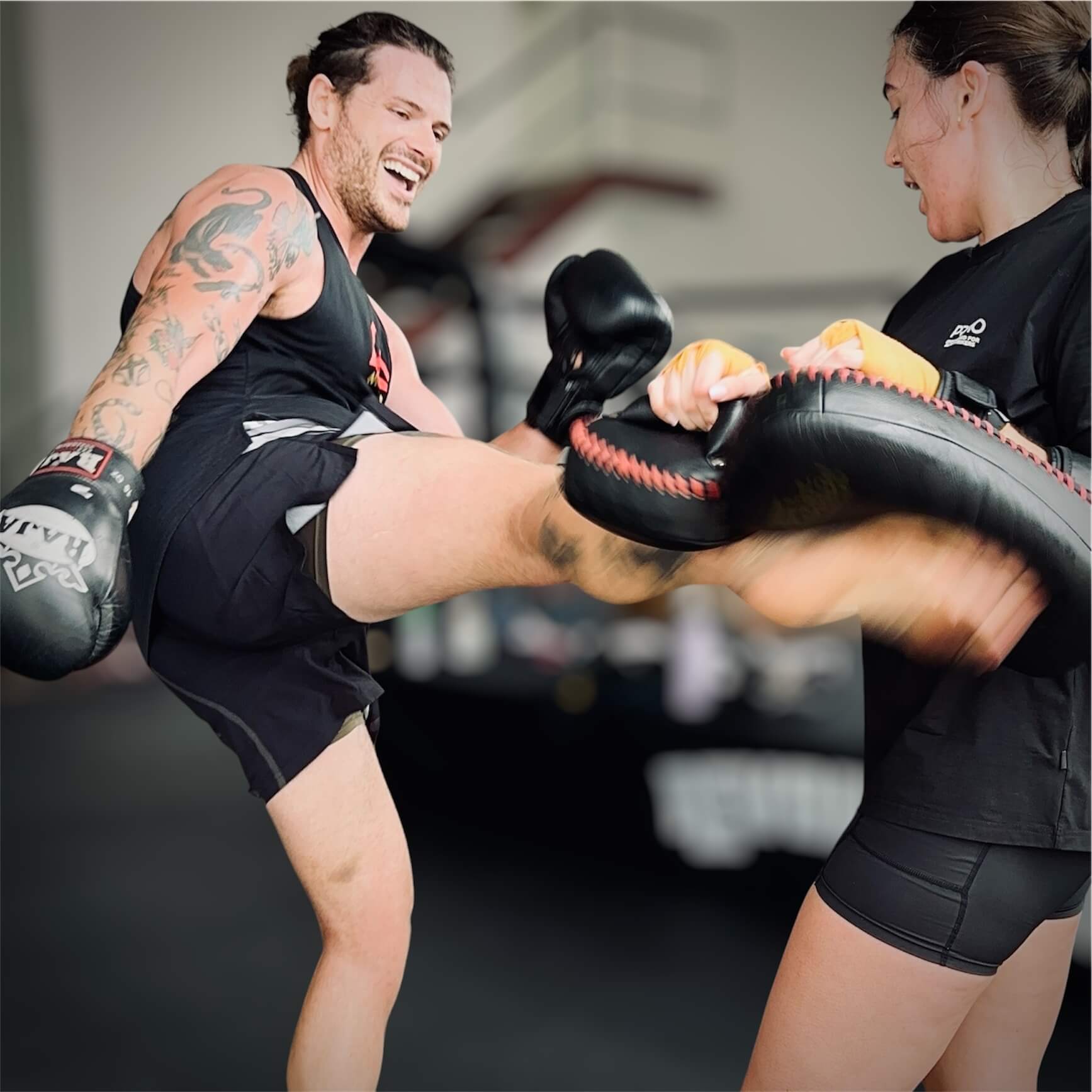 Members practising kicks and pad work at Revolution