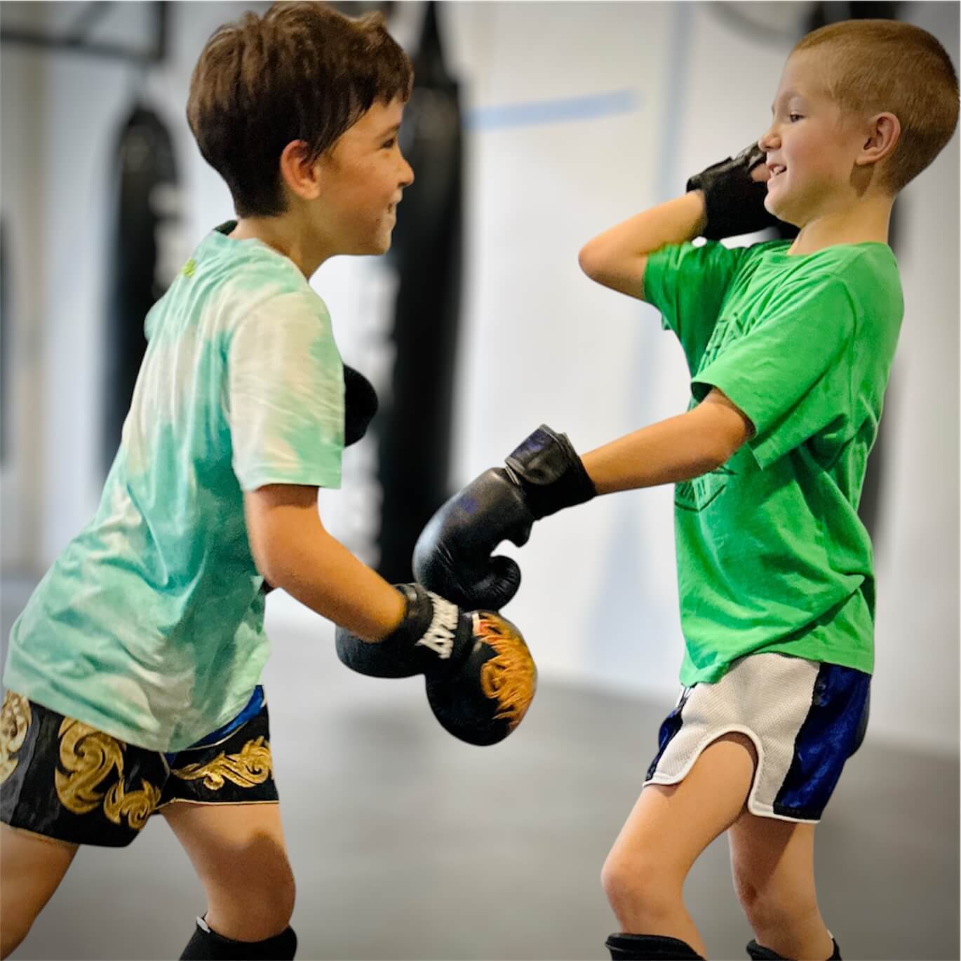 Children smiling during a partner training exercise